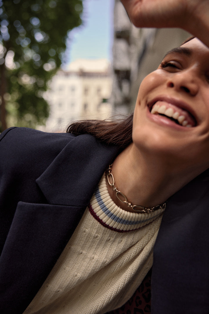 Ecru Pearl sweater with blue and red trim